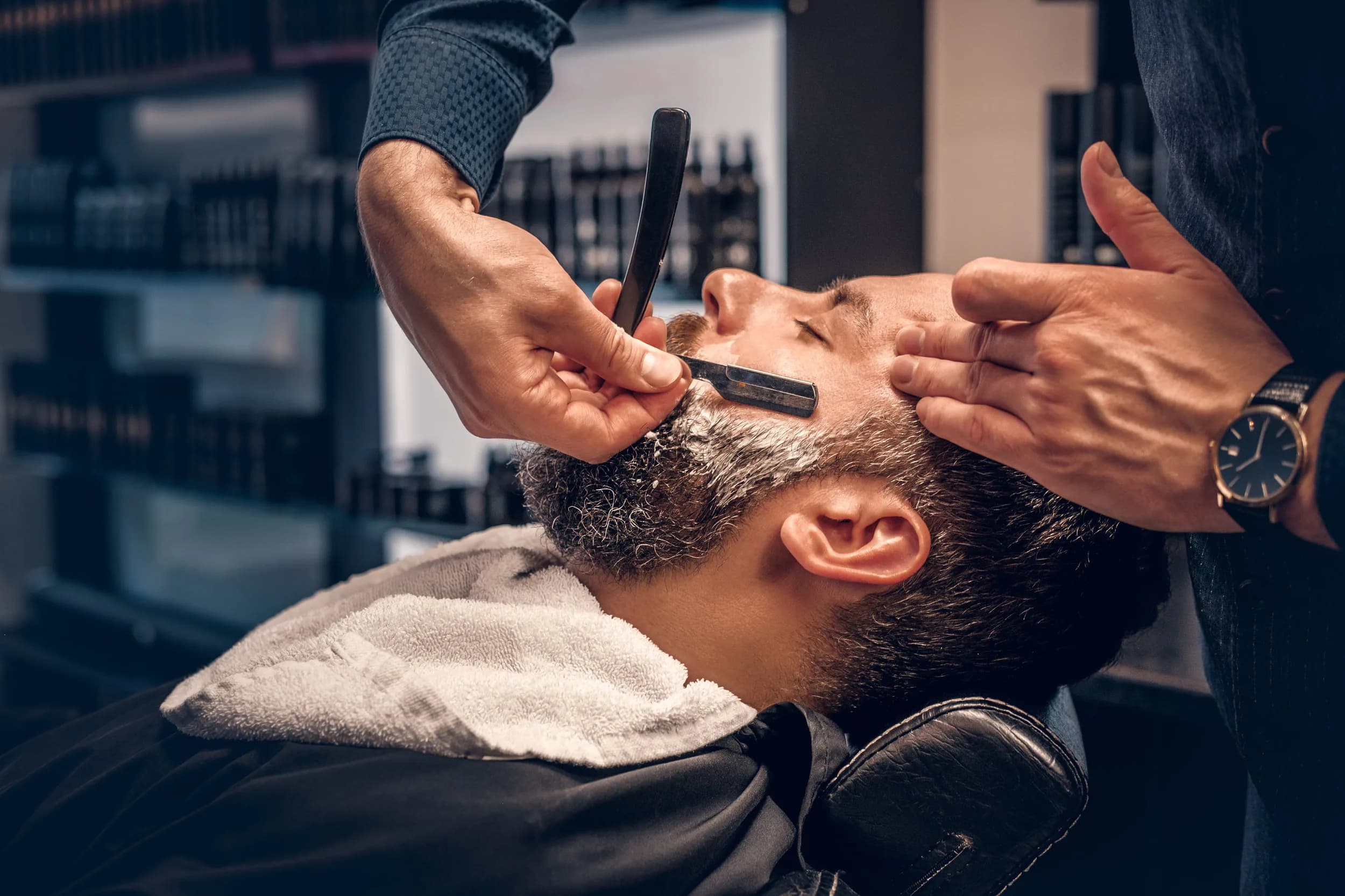 Straight razor shave in progress at Grove Batu Barbershop in Coconut Grove, Miami