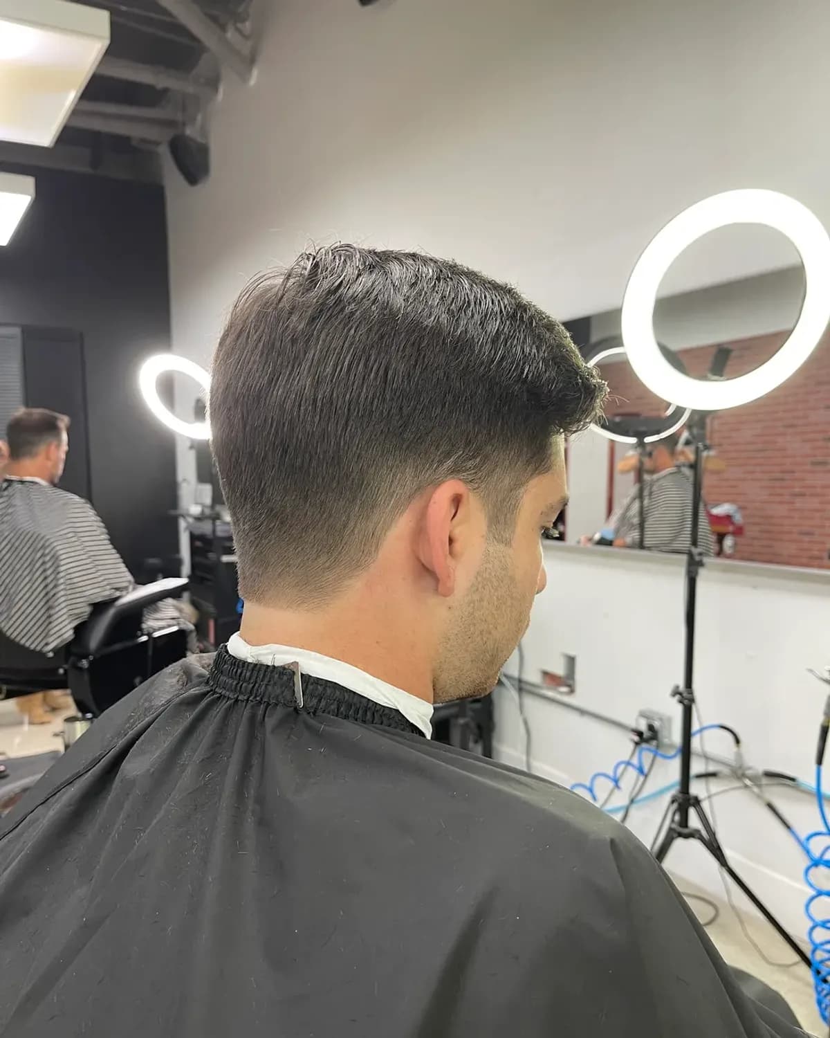 Skin fade taken tight to the sides, finished at Grove Batu in Coconut Grove